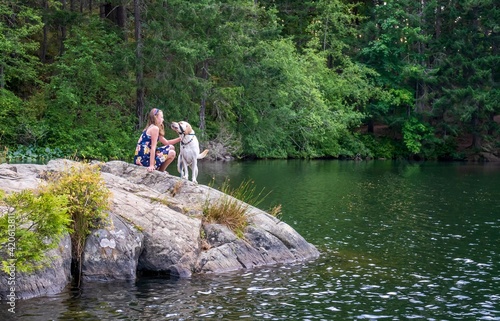 Child with her dog on a scenic rock outcropping- Thetis lake, greater Victoria, Vancouver island, British Columbia, Canada 