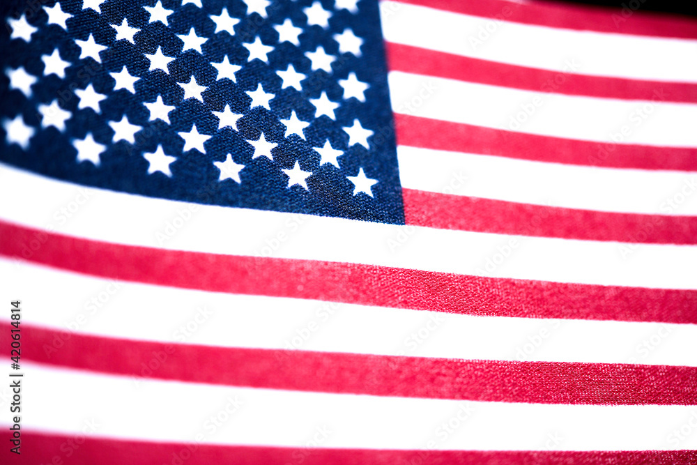 Naklejka premium Macro Shot Of Handheld American Flag On Coarse Fabric