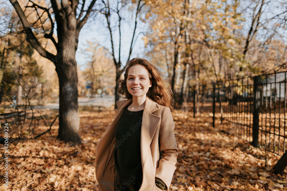 Portrait of a red-haired young girl in autumn outdoors. Portrait of a red-haired young girl in autumn outdoors.
