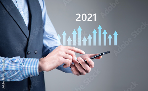 holding smartphone and financial chart graph 2021