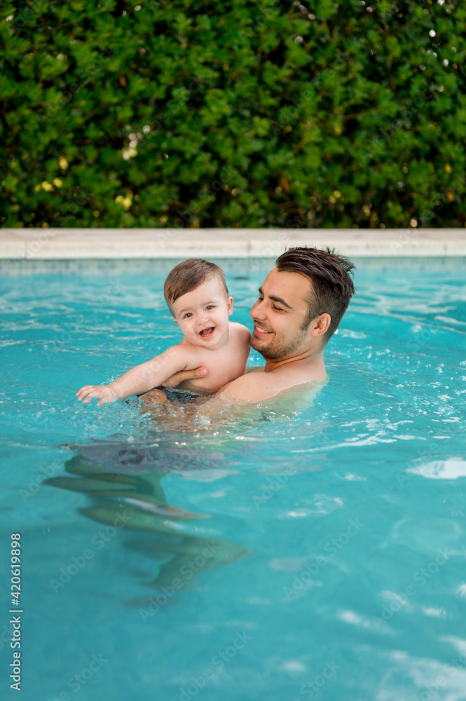 Father and baby in swimming pool Father and baby in swimming pool