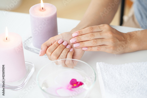 Woman making manicure when resting at home