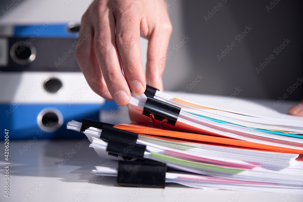 man holding stack of documents man holding stack of documents