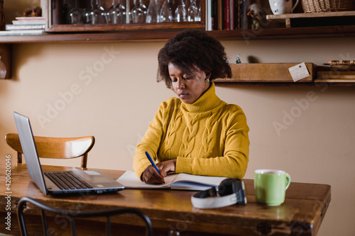 Black woman using laptop during smartworking. Lifestyle images. photo