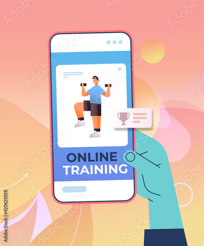 hand using mobile fitness app man doing physical exercises with dumbbells on smartphone screen training workout