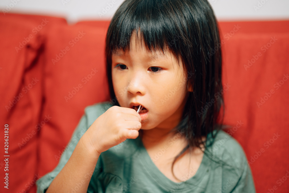 Little girl flossing teeth