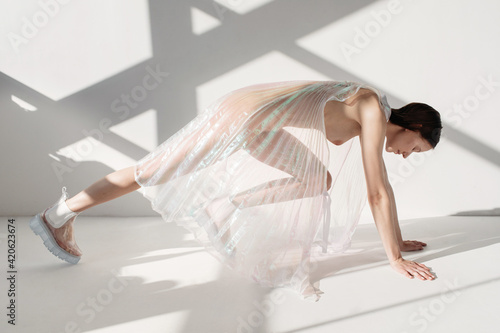 Woman in transparent dress ready to run photo
