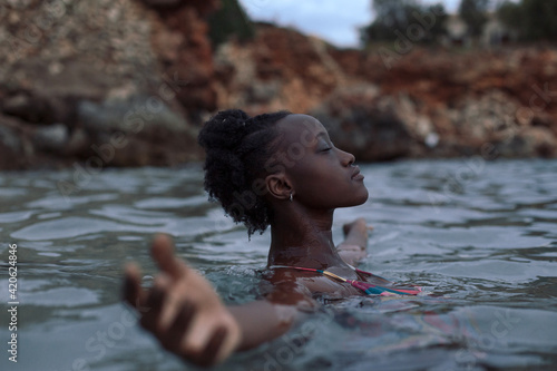 Black woman relaxing in the sea photo