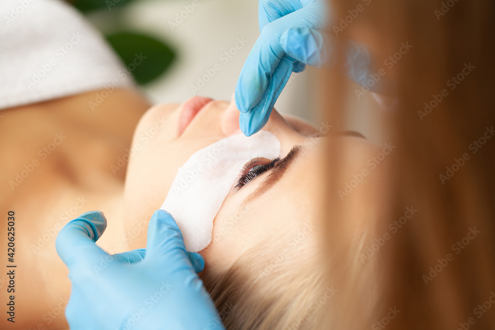 Eyelash extension procedure, a professional stylist lengthens women eyelashes. Eyelash extension procedure, a professional stylist lengthens women eyelashes.