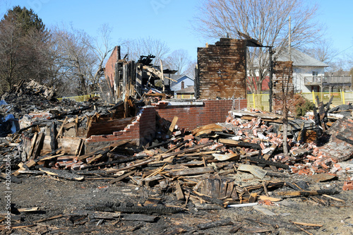 Burned out building, the remnants of a restaurant that was in a century house leaving heaps of rubble