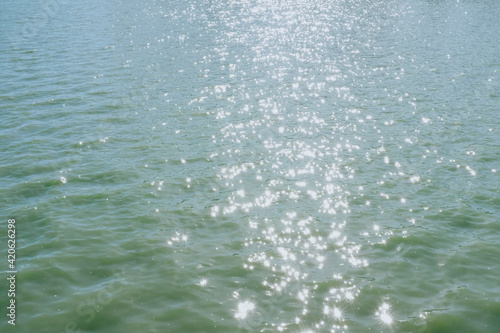 Sparkling sunlight on the watery lake surface photo