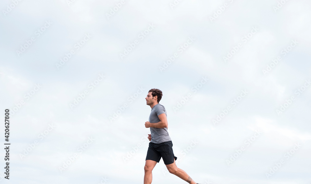 Running Sportsman On Paved Waterfront Running Sportsman On Paved Waterfront
