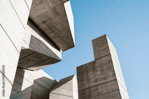 Minimal concrete geometrical architectural structures against blue sky photo