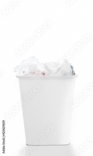 Loaded of clean shopping plastic bags in recycle bin on white background, cause effect of global warming. Concept of care and responsibility for reusable management, trash separation.