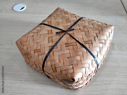 a wrap made of woven bamboo called besek photo