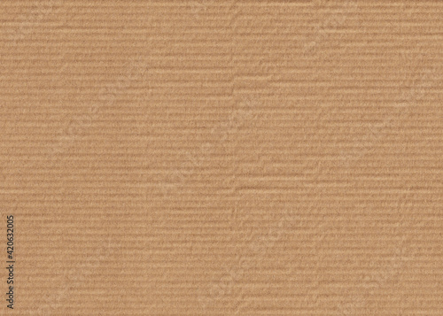 Cardboard background. Corrugated board in beige, light brown color. Textured surface template for banner, poster. Horizontal photo