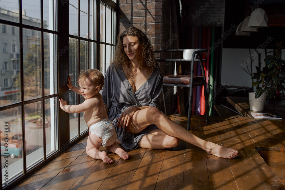 © Tatiana Timofeeva/Stocksy - a young mother with a baby girl, curly hair woman with his beloved daughter © Tatiana Timofeeva/Stocksy - a young mother with a baby girl, curly hair woman with his beloved daughter