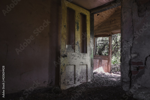 The doorway of a decaying old ruined house.
