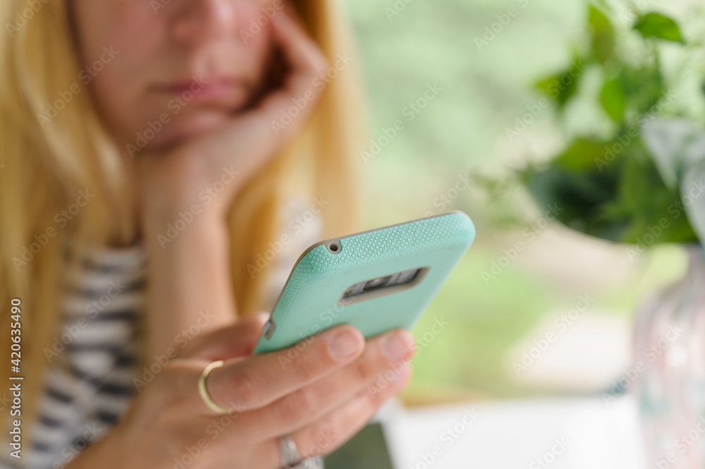 © jamie grill photography/Stocksy - Upset Woman Looking at Smartphone
