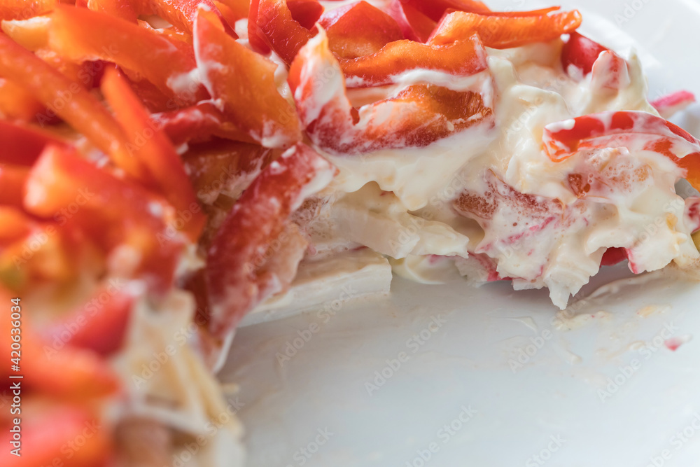 Red bell pepper salad. Pieces of sweet red pepper, tomato, crab meat and cheese in mayonnaise, macro photography. Food backgrounds. Red bell pepper salad. Pieces of sweet red pepper, tomato, crab meat and cheese in mayonnaise, macro photography. Food backgrounds.