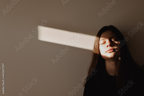 Teen girl turning toward the light photo