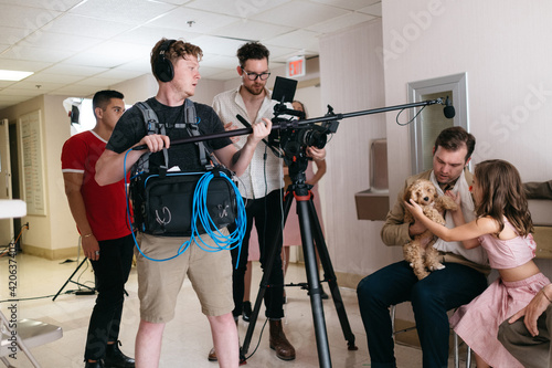 Actors perform their scene in front of a film crew