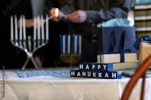 Hanukkah: Blocks With Holiday Message In Front Of Menorah Lighti photo