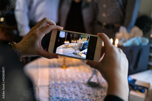 Hanukkah: Anonymous Teen Girl Takes A Photo Of Menorah With Cell photo