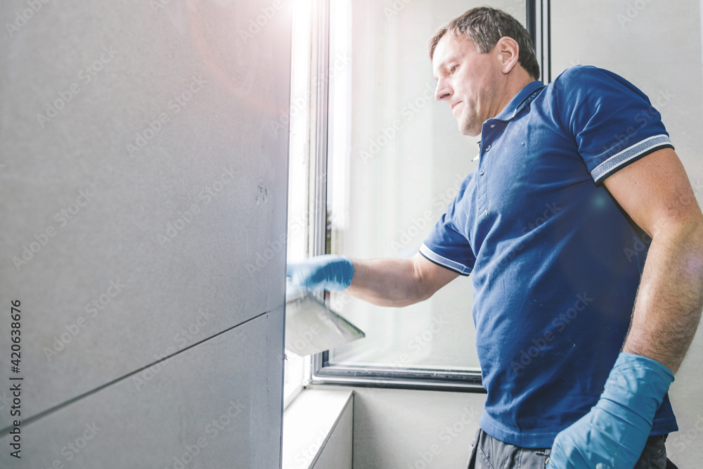 Grouting the tiles with the tile grout