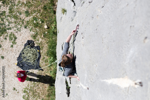 Adventurous Woman Rock Climbing Outdoors photo