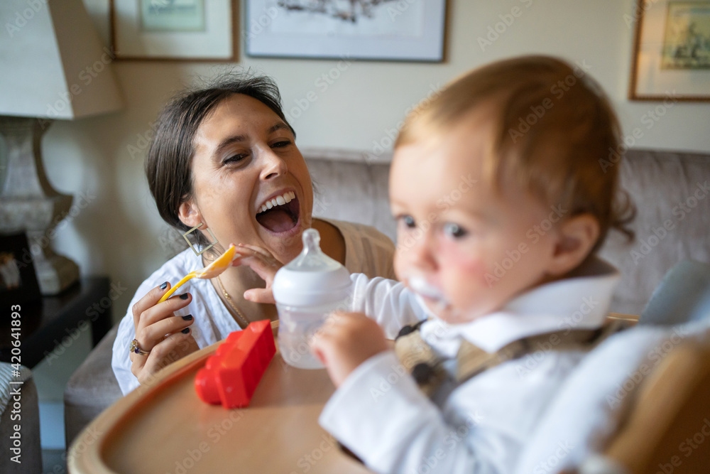 Funny Mom Feeding To Her Baby At Home. Funny Mom Feeding To Her Baby At Home.