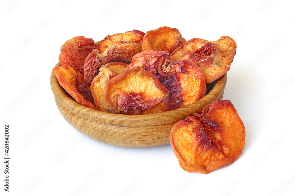Halves dried peaches in the basket  isolated on white