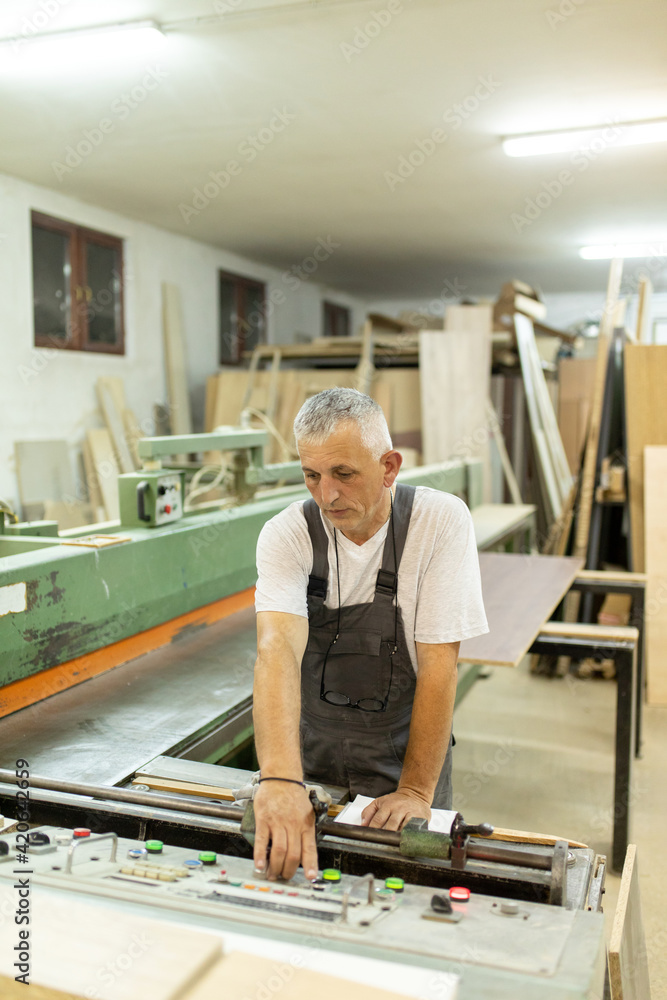 Carpenter working in a workshop Carpenter working in a workshop