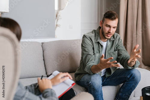 Worried man speaking with psychologist