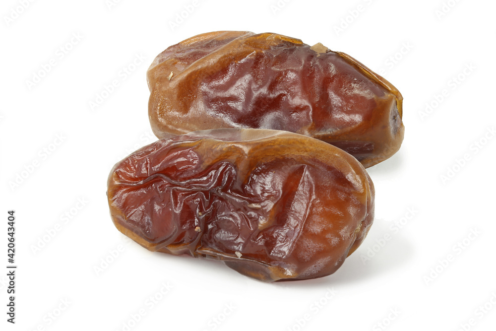 Two dried tasty dates isolated on white Two dried tasty dates isolated on white