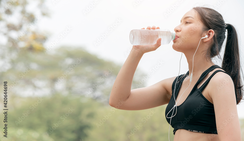 Beautiful fitness athlete woman drinking water after work out exercising. Beautiful fitness athlete woman drinking water after work out exercising.