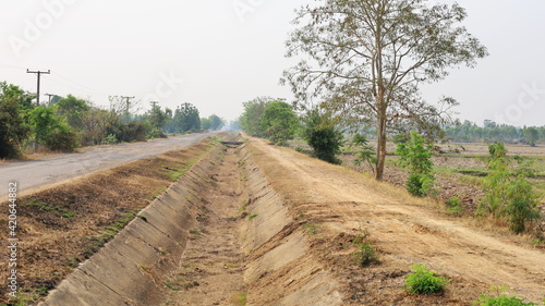 Barren irrigation canals. Concrete canals pass through farmland areas that do not have water due to global warming. Selective focus