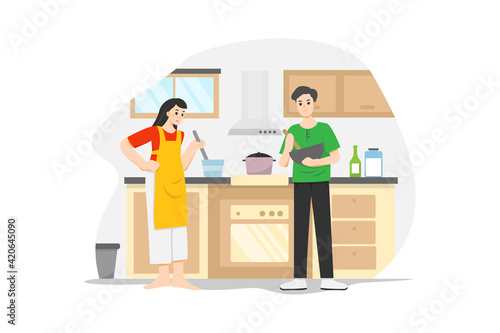 A woman in the apron and a man cooking together during the quarantine time