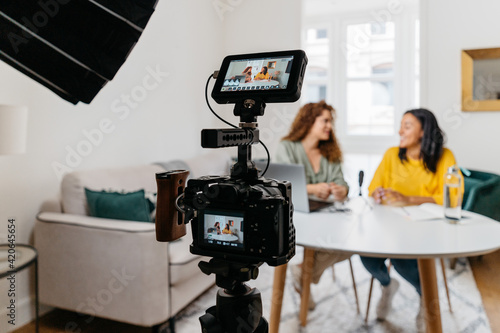 Ethnic women recording podcast together photo