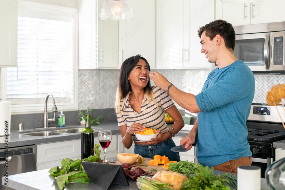 Man Playfully Feeding His Girlfriend Man Playfully Feeding His Girlfriend