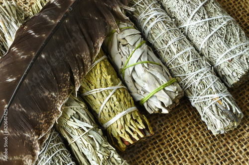 A top view image of several healing sage smudge sticks bundles. 