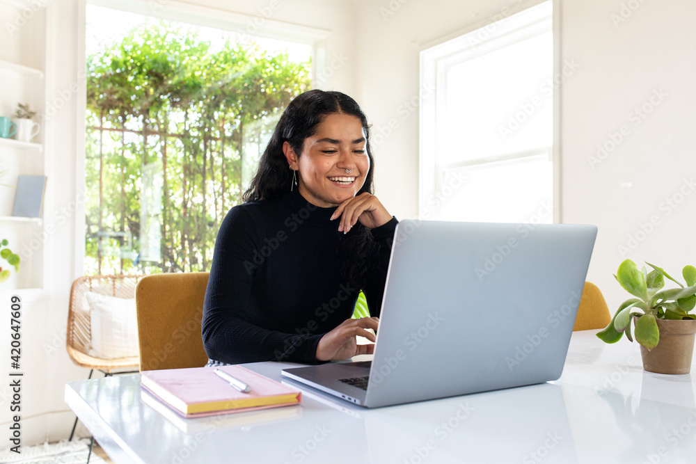Female Entrepreneurs Smiles While Typing On Her Laptop Female Entrepreneurs Smiles While Typing On Her Laptop