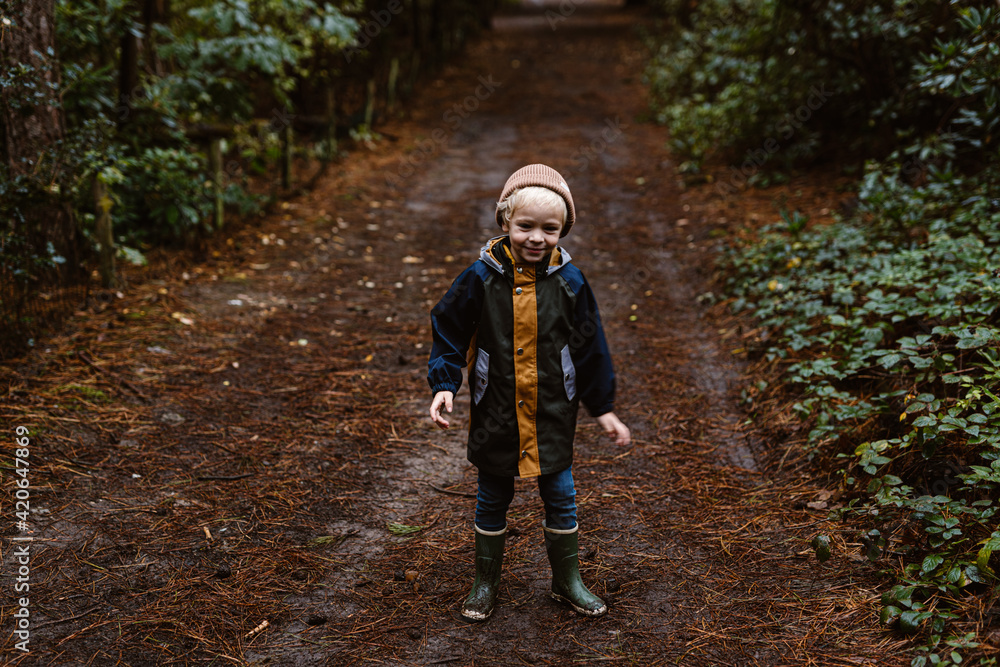 Little blond toddler boy looking happy in the forest Little blond toddler boy looking happy in the forest