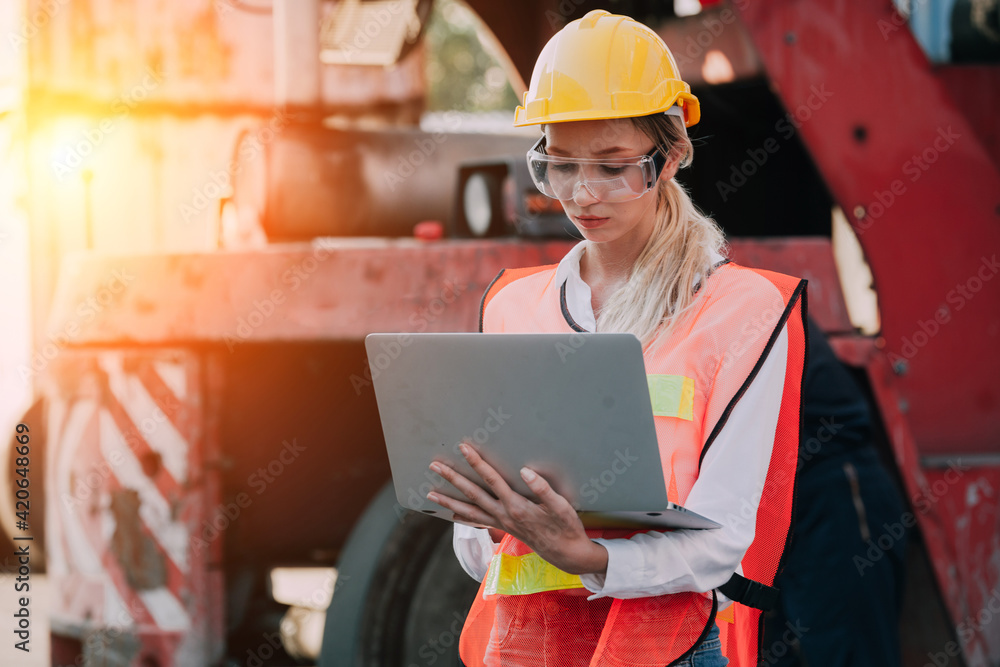woman working with laptop in cargo container. Containers box from Cargo freight ship for import export. Business logistic concept, Import and export concept woman working with laptop in cargo container. Containers box from Cargo freight ship for import export. Business logistic concept, Import and export concept