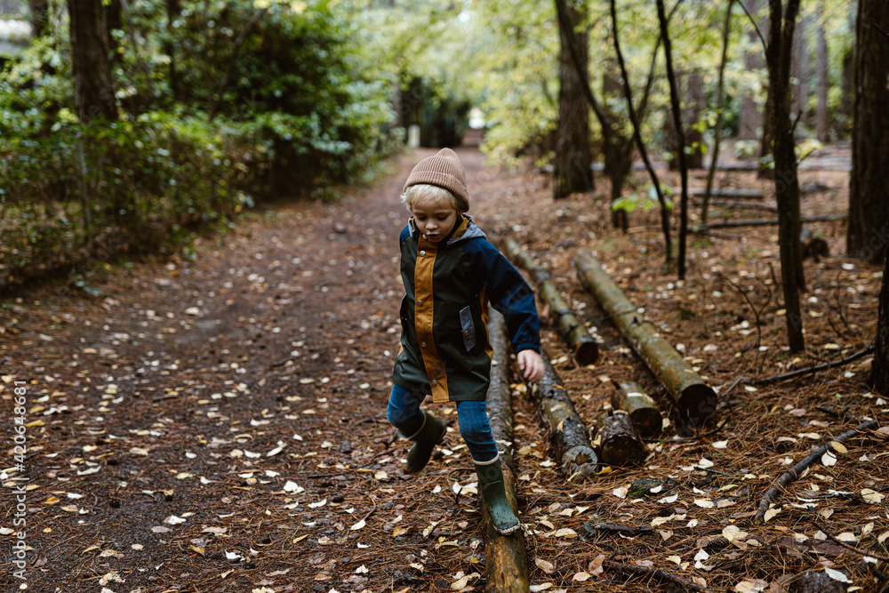 Little blond toddler boy playing in the woods Little blond toddler boy playing in the woods