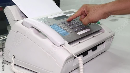 hand man are using a fax machine in the office, equipment for data transmission