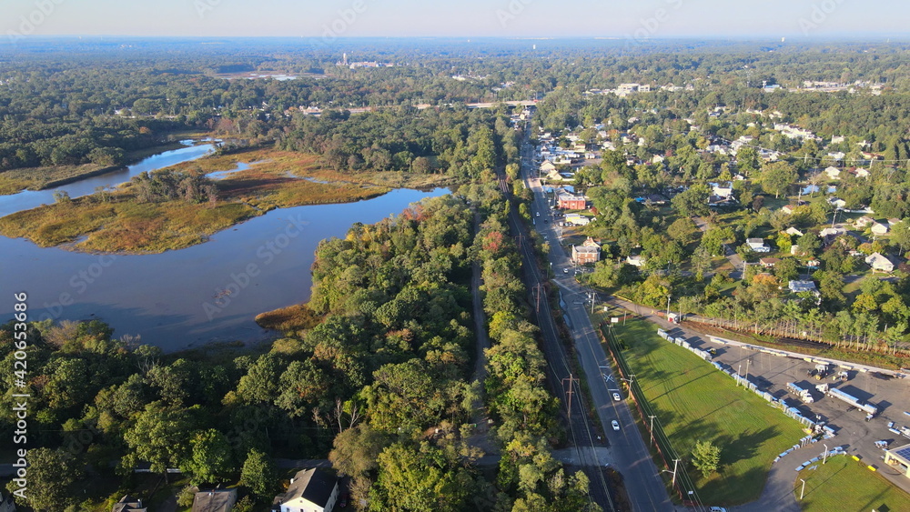 Fototapeta premium Aerial view of road at downtown of small town the traffic car road near river