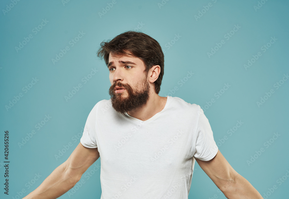 Emotional guy gesturing with his hands on a blue background Copy Space Model cropped view Emotional guy gesturing with his hands on a blue background Copy Space Model cropped view