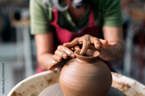 Woman Making Pottery On Spinning Wheel