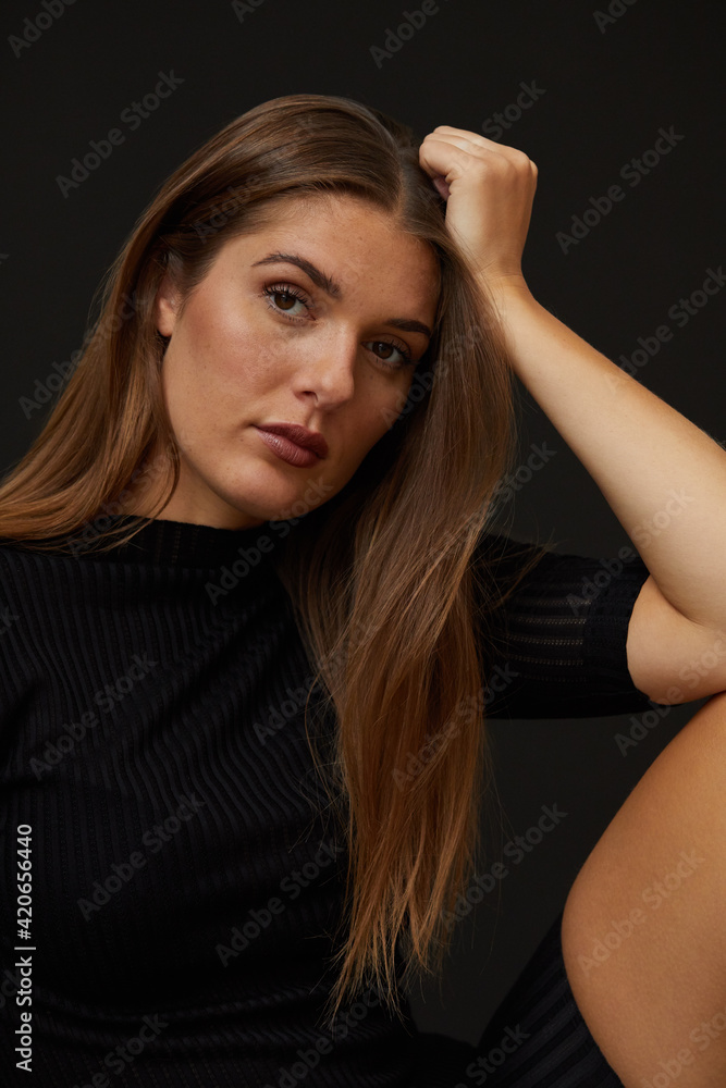 Young woman in fashionable black sweater Young woman in fashionable black sweater